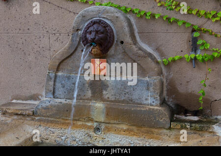 Ancient spring water fountain in Rue de Porche, Grimaud, France Stock Photo