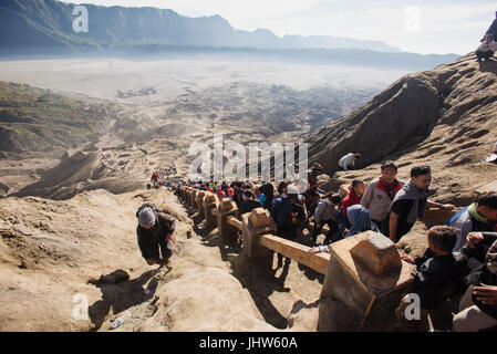 Tourists climbing to caldeira of Mount Bromo active volcano, East Java INdonesia. Stock Photo
