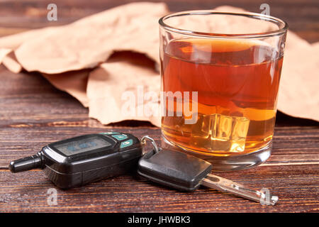 Glass of whisky, car keys, paper. Stock Photo