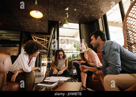 Team of corporate professionals having friendly discussion in a meeting. Multi ethnic business team having project discussion. Stock Photo