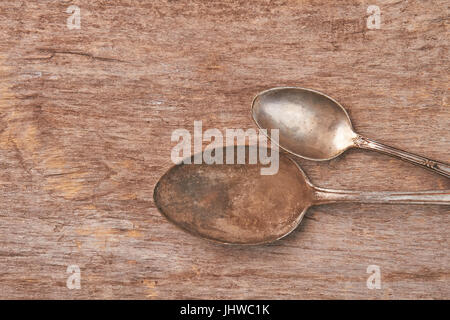 Vintage rusty spoons on wooden background. Stock Photo