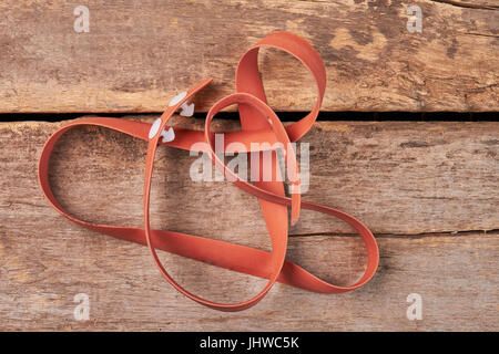 Brown tourniquet on wooden background. Stock Photo