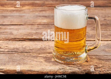 Glass mug with beer and foam. Stock Photo
