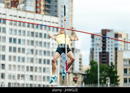 failed attempt at pole vaulting male athlete during Ural Championship in athletics Stock Photo