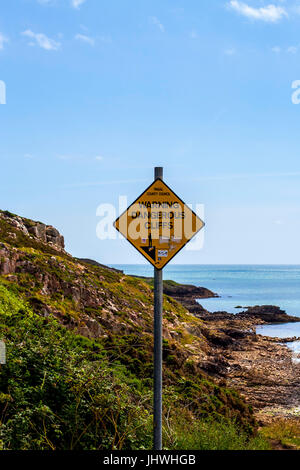 Warning, dangerous cliffs yellow diamond shaped sign Stock Photo