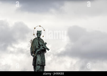Historic religious statue against dramatic sky Stock Photo