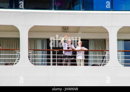 2 passengers waving on a Cruise ship in the Panama Canal Stock Photo