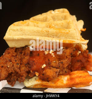 Belgian waffle sandwich with hot battered chicken, feta cheese, hot sauce and spices Stock Photo