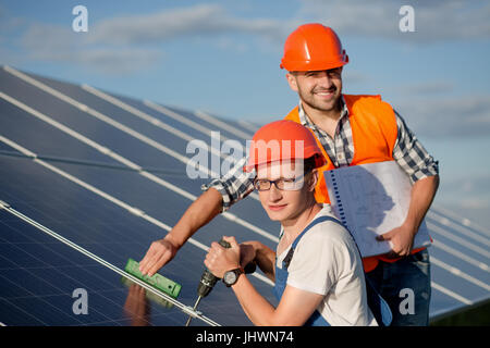 Engineers installing solar panels. Stock Photo