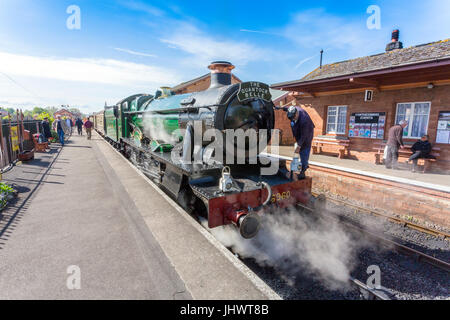 The driver of ex-GWR loco 6960 'Raveningham Hall' puts a headlamp on the engine in Bishops Lydeard station before taking the train to Minehead on the 