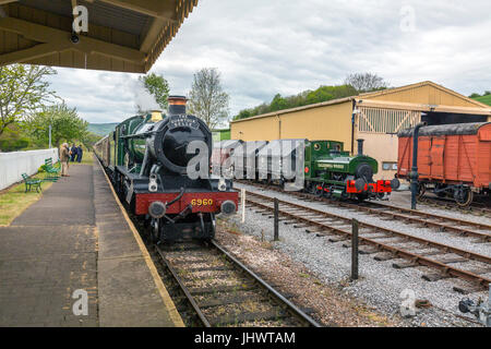 Ex-GWR loco 6960 'Raveningham Hall' arrives in Washford station with a train to Bishops Lydeard on the West Somerset Railway, UK