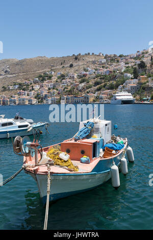 Symi Island, South Aegean, Greece - a fishing boat in the harbour at the main town / port, Gialos (or Yialos, as it is also known) Stock Photo