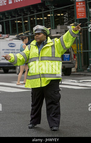 Female New York City Traffic Enforcement Officer directing cars at East 34th Street and Park Avenue in New York City. Stock Photo