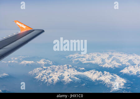 View of Easy Jet airplane wing from the window flying over the Alps Stock Photo