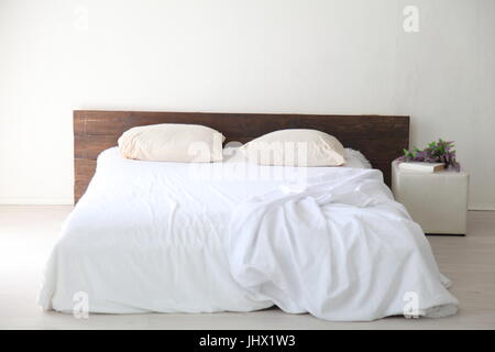 White bedroom bright interiors with bed Stock Photo