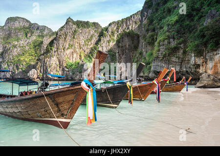 Thailand sea beach view round with steep limestone hills with many traditional longtail boats parking at Maya Bay, Ko Phi Phi Leh island, part of Krab Stock Photo