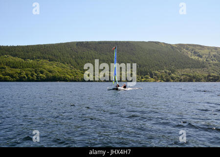 Catamaran sailing boat on Coniston Water in the Lake District Cumbria England Stock Photo
