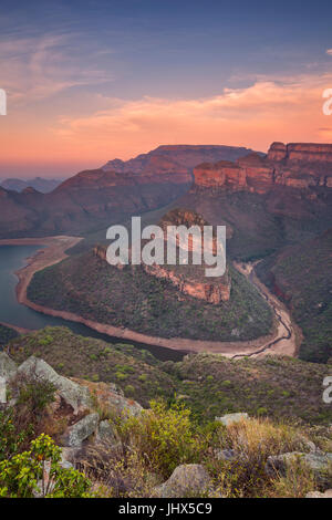 View over the Blyde River Canyon and the Three Rondavels in South Africa at sunset. Stock Photo