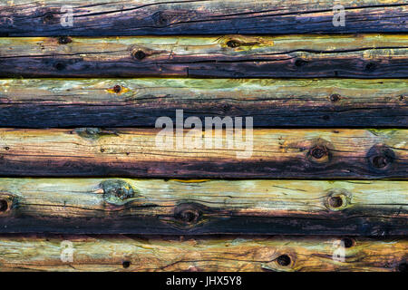 Natural colorful weathered log cabin wood wall. Wooden background pattern. Stock Photo