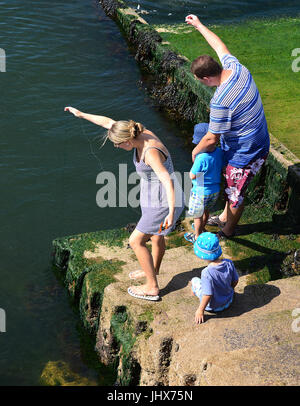 Mum, Dad and two kids crab fishing off Berry Head, Torbay, Devon Stock Photo