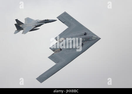 RAF Fairford, UK. 16th July, 2017. Visitors watched military and civilian aircraft taking to the sky in one of the most spectacular displays at this year's RIAT Air Show. Flypast of the  Rockwell B2 Stealth Bomber with a Lockheed Martin F22 Raptor  to mark the 70th anniversary of the US Air Force. Credit: Uwe Deffner/Alamy Live News Stock Photo