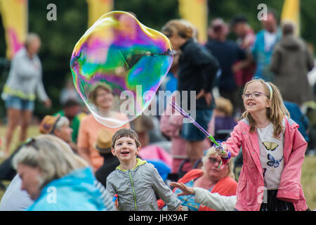 Latitude Festival, UK 16th July, 2017 Children continue to have fun with bubbles - The 2017 Latitude Festival, Henham Park. Suffolk 16 July 2017 Credit: Guy Bell/Alamy Live News Stock Photo