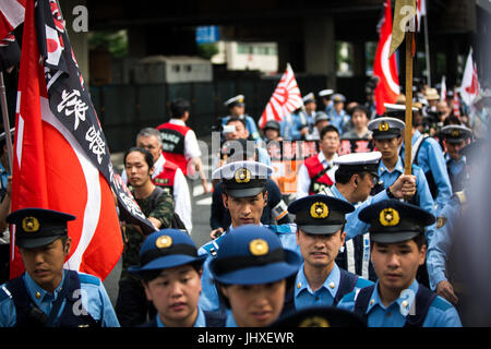 TOKYO, JAPAN - JULY 16: Japanese nationalists holding Japanese maritime flags, escorted by police, took to the streets in a 'hate demonstration' in Akihabara, Tokyo, Japan on July 16, 2017. The nationalists faced off with anti-racist groups who mounted counter protests demanding an end to hate speech and racism in Japan. Credit: Richard Atrero de Guzman/AFLO/Alamy Live News Stock Photo