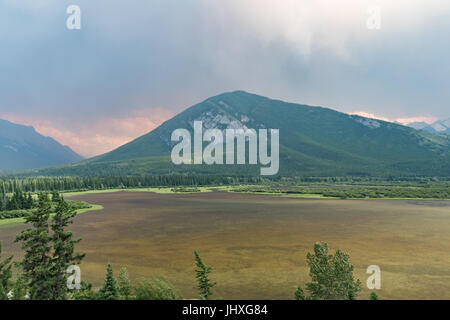 Banff, Canada. 16th July, 2017. Forest fire smoke & ash changes the previously blue/green waters of Vermillion Lake, Banff National Park, Canada. The nearby forest fire left the lakes un recognisable as they changed from a lovely blue/green to a more brown colour. The forest fire  is believed to be from Verdant Creek.Credit: Andy Oliver/Alamy Live News Stock Photo