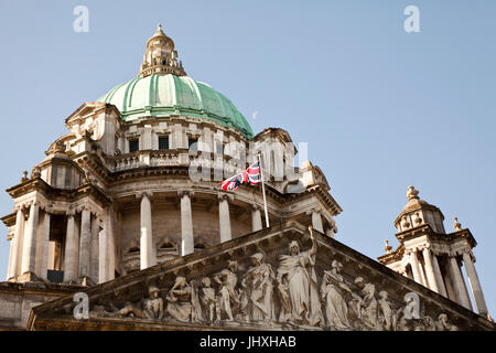 Belfast, UK. 17th July, 2017.  The Union Flag is hoisted up the flag pole on Belfast City hall to Commemorate The Duchess of Cornwall's 70th Birthday. Credit: Bonzo/Alamy Live News Stock Photo