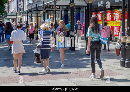 Southport, Merseyside, UK. 17th July, 2017. Busy Town Centre, with tourists and shoppers enjoying the sunshine and hot weather on Open Golf Week. The Championship is based at Royal Birkdale and up to 40,000 spectators are expected in the resort to sample the shopping in Lord Street and the Golf Based attractions in the Princess Diana Gardens in front of The Atkinson in Southport Central Business District. Credit: MediaWorldImages/Alamy Live News Stock Photo