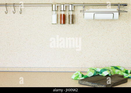 Kitchen marble table with cutting board and various spices. Modern kitchen interior. Copy space. Stock Photo