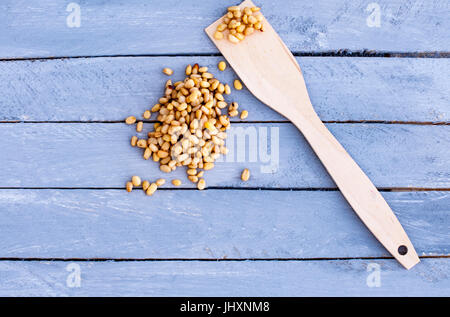 Nuts of pine nuts on a wooden background of a gray-blue color. Stock Photo