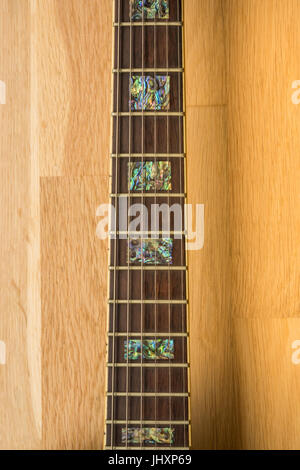 Close up of guitar neck of Antonio Sanchez classical guitar with mother of pearl inlay and strings Stock Photo