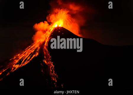 Lava spurts from erupting Fuego volcano near Antigua, Guatemala, Central America Stock Photo