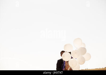 Married happy couple holding ballons in hand Stock Photo - Alamy