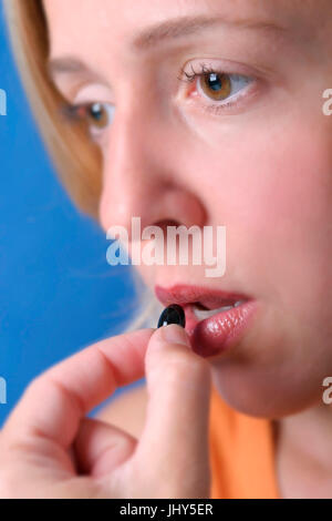 Woman takes tablet, Frau nimmt Tablette Stock Photo