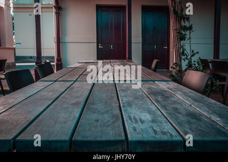 Long rustic wooden picnic table with copy space Stock Photo