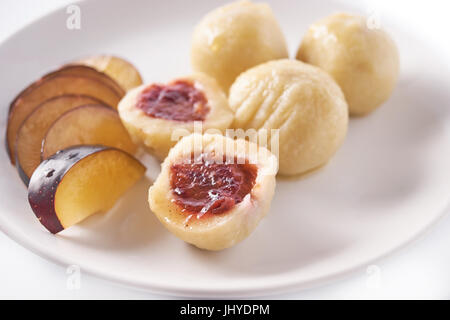 Austrian traditional dumplings filled with plum on white Stock Photo