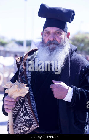 Man wearing the traditional Berritta Sardinian hat and carring the traditional Sardinian sac, St. Antioco, Sardinia, Italy Stock Photo