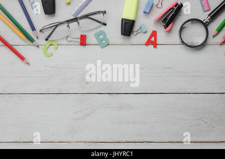 Top view business office supply and education concept background.the stationery alphabet word maker pen eyeglasses beautiful color pencil staple on wh Stock Photo