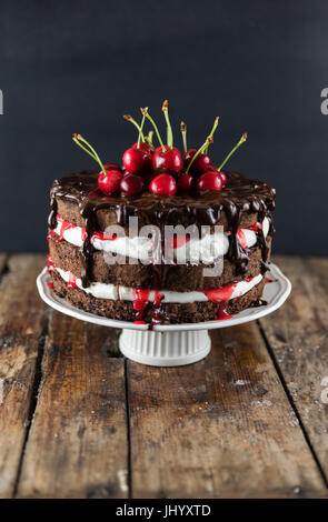 Black forest cake, Schwarzwald cake, dark chocolate and cherry dessert on a wood table modern Cake Stock Photo