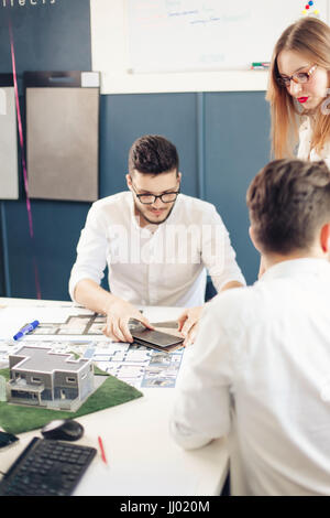 Confident team of engineers working together in a architect studio Stock Photo
