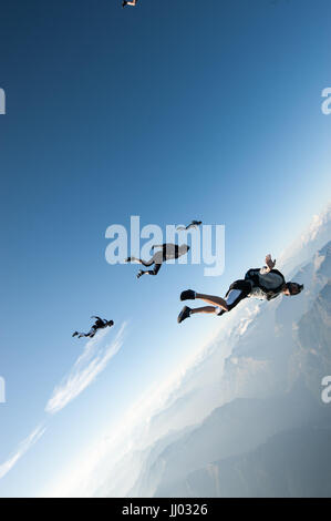 A skydiver tracking over Locarno, Witzerland with the Alps in the background Stock Photo