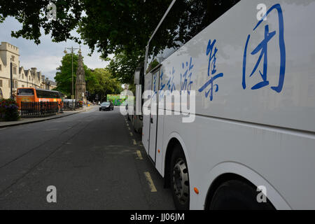 Tourist bus with Chinese lettering and logos deposits passengers in Oxford Stock Photo
