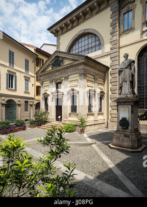 Milan. Italy. Original entrance to the Biblioteca Ambrosiana on Piazza San Sepolcro, opened 1609, and statue of Cardinal Federico Borromeo (1564–1631) Stock Photo