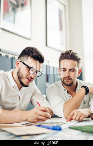 two handsome men architect looking at plans Stock Photo