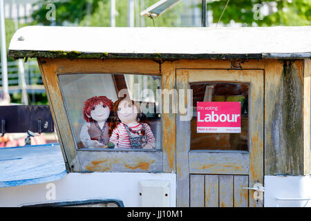 A vote Labour Party poster displayed on a boat in Bristol city docks, By its side are two Rosie and Jim children's story characters looking out of the Stock Photo