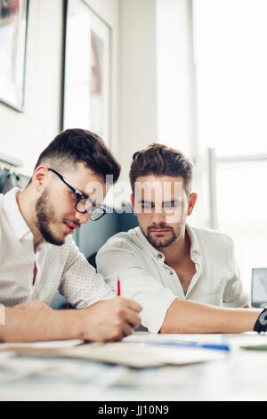 two handsome men architect looking at plans Stock Photo