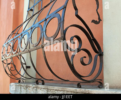 Ornate wrought iron security bars on the window Stock Photo