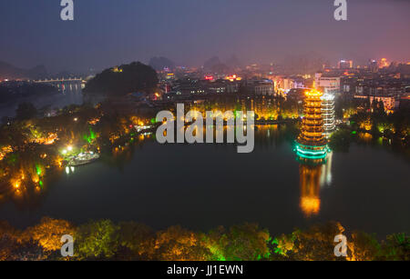 Evening view of the Gold and Silver Pagodas, also known as the Sun and Moon Pagodas, reflected in Shan Lake  Guilin, Guangxi Province, China. Stock Photo